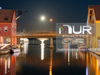 A general view of Fiskebrygga (The Fish Wharf) at night with moon reflecting on sea, in Kristiansand, Norway on September 13, 2024. Fiskebry...