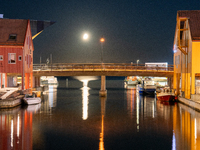 A general view of Fiskebrygga (The Fish Wharf) at night with moon reflecting on sea, in Kristiansand, Norway on September 13, 2024. Fiskebry...