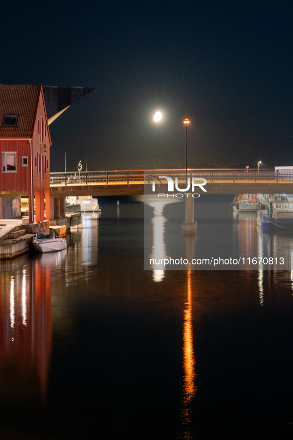 A general view of Fiskebrygga (The Fish Wharf) at night with moon reflecting on sea, in Kristiansand, Norway on September 13, 2024. Fiskebry...