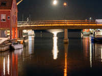 A general view of Fiskebrygga (The Fish Wharf) at night with moon reflecting on sea, in Kristiansand, Norway on September 13, 2024. Fiskebry...