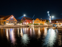 A general view of Fiskebrygga (The Fish Wharf) at night, in Kristiansand, Norway on September 13, 2024. Fiskebrygga  is a former fish landin...