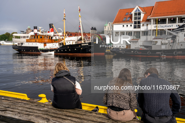 Tourists near the harbor of  Bergen, Norway, on September 16, 2024. Bergen is the second-largest city in Norway, with a population of approx...