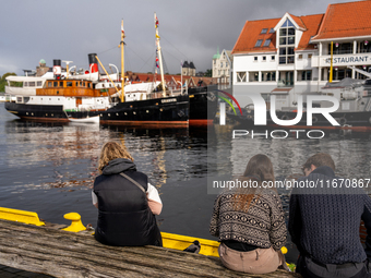 Tourists near the harbor of  Bergen, Norway, on September 16, 2024. Bergen is the second-largest city in Norway, with a population of approx...