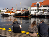 Tourists near the harbor of  Bergen, Norway, on September 16, 2024. Bergen is the second-largest city in Norway, with a population of approx...