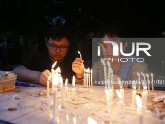 Devotees light candles during the celebrations to mark the Buddhist festival of Probarona Purnima in Dhaka, Bangladesh, on October 16, 2024....