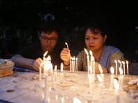 Devotees light candles during the celebrations to mark the Buddhist festival of Probarona Purnima in Dhaka, Bangladesh, on October 16, 2024....