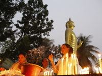 Devotees light candles during the celebrations to mark the Buddhist festival of Probarona Purnima in Dhaka, Bangladesh, on October 16, 2024....