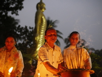 Devotees light candles during the celebrations to mark the Buddhist festival of Probarona Purnima in Dhaka, Bangladesh, on October 16, 2024....