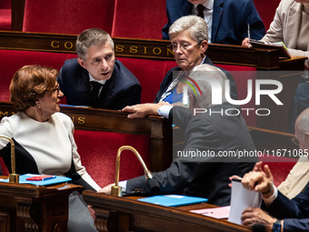 Gil Averous, Minister of Sports and Youth, talks with Prime Minister Michel Barnier among the government benches during question time in Par...