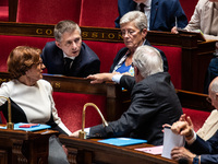 Gil Averous, Minister of Sports and Youth, talks with Prime Minister Michel Barnier among the government benches during question time in Par...