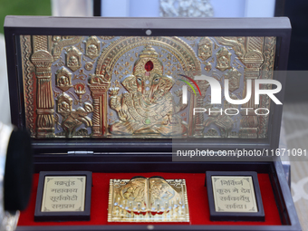 Pure silver and gold-plated puja items are displayed at a small stall selling various puja items during the Sree Ganesh Chaturthi Mahotsav f...