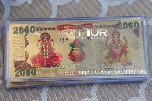 Swiss gold bars with the images of the Goddess Lakshmi and Lord Ganesh are displayed at a small stall selling various puja items during the...