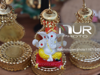 A small idol of Lord Ganesh is displayed at a stall selling various puja items during the Sree Ganesh Chaturthi Mahotsav festival in Brampto...