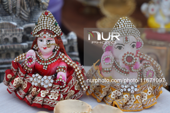 Small idols of Hindu deities are displayed at a small stall selling various puja items during the Sree Ganesh Chaturthi Mahotsav festival in...