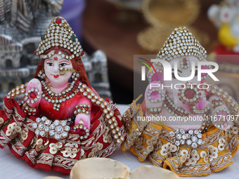 Small idols of Hindu deities are displayed at a small stall selling various puja items during the Sree Ganesh Chaturthi Mahotsav festival in...