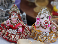 Small idols of Hindu deities are displayed at a small stall selling various puja items during the Sree Ganesh Chaturthi Mahotsav festival in...