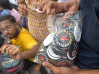 A person sells badges at the Junior doctors' protest site. Junior doctors continue their indefinite hunger strike for the rape and murder of...