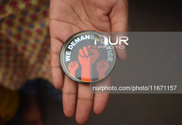 A woman shows a badge at the Junior doctors' protest site. Junior doctors continue their indefinite hunger strike regarding the alleged rape...