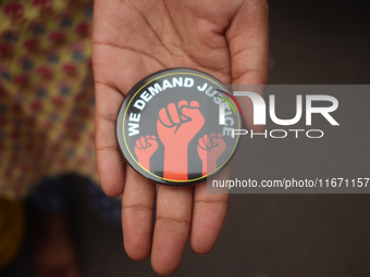 A woman shows a badge at the Junior doctors' protest site. Junior doctors continue their indefinite hunger strike regarding the alleged rape...