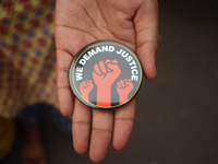 A woman shows a badge at the Junior doctors' protest site. Junior doctors continue their indefinite hunger strike regarding the alleged rape...