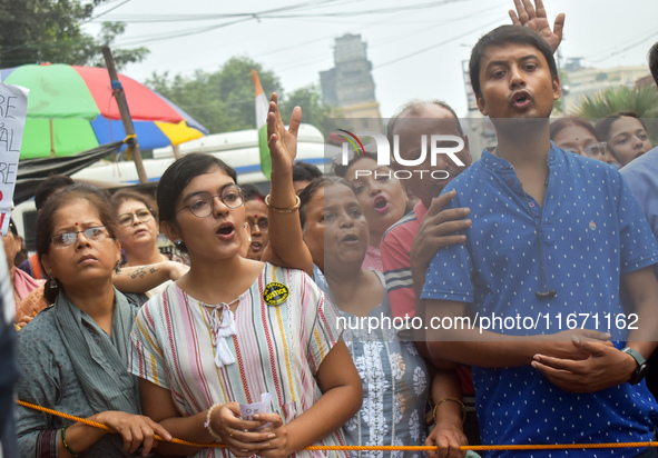 Citizens shout slogans while they attend the Junior Doctors hunger strike to protest the rape and murder case of a medic in a government-run...