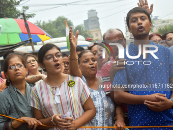 Citizens shout slogans while they attend the Junior Doctors hunger strike to protest the rape and murder case of a medic in a government-run...