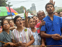 Citizens shout slogans while they attend the Junior Doctors hunger strike to protest the rape and murder case of a medic in a government-run...