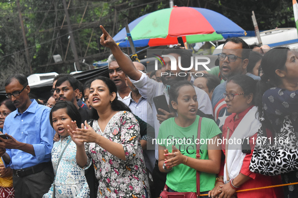 Citizens shout slogans while they attend the Junior Doctors hunger strike to protest the rape and murder case of a medic in a government-run...