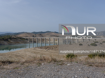 Visible banks, dry soil, and uncultivated vegetation replace the water at Lake Monte Cotugno, a reservoir in Basilicata, which in the summer...