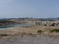 Visible banks, dry soil, and uncultivated vegetation replace the water at Lake Monte Cotugno, a reservoir in Basilicata, which in the summer...