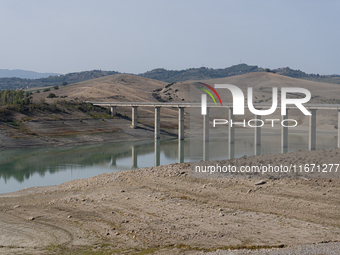 Visible banks, dry soil, and uncultivated vegetation replace the water at Lake Monte Cotugno, a reservoir in Basilicata, which in the summer...