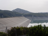 Visible banks, dry soil, and uncultivated vegetation replace the water at Lake Monte Cotugno, a reservoir in Basilicata, which in the summer...