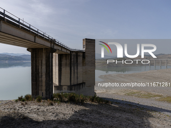 Visible banks, dry soil, and uncultivated vegetation replace the water at Lake Monte Cotugno, a reservoir in Basilicata, which in the summer...