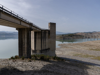 Visible banks, dry soil, and uncultivated vegetation replace the water at Lake Monte Cotugno, a reservoir in Basilicata, which in the summer...