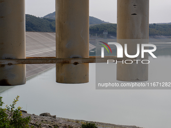 Visible banks, dry soil, and uncultivated vegetation replace the water at Lake Monte Cotugno, a reservoir in Basilicata, which in the summer...