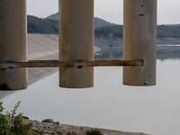 Visible banks, dry soil, and uncultivated vegetation replace the water at Lake Monte Cotugno, a reservoir in Basilicata, which in the summer...