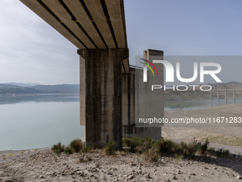 Visible banks, dry soil, and uncultivated vegetation replace the water at Lake Monte Cotugno, a reservoir in Basilicata, which in the summer...