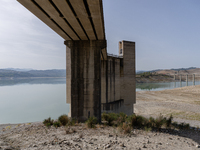 Visible banks, dry soil, and uncultivated vegetation replace the water at Lake Monte Cotugno, a reservoir in Basilicata, which in the summer...