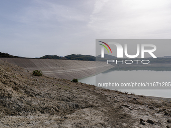 Visible banks, dry soil, and uncultivated vegetation replace the water at Lake Monte Cotugno, a reservoir in Basilicata, which in the summer...