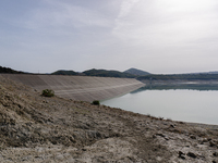 Visible banks, dry soil, and uncultivated vegetation replace the water at Lake Monte Cotugno, a reservoir in Basilicata, which in the summer...