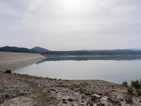 Visible banks, dry soil, and uncultivated vegetation replace the water at Lake Monte Cotugno, a reservoir in Basilicata, which in the summer...