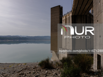 Visible banks, dry soil, and uncultivated vegetation replace the water at Lake Monte Cotugno, a reservoir in Basilicata, which in the summer...