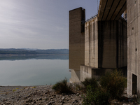 Visible banks, dry soil, and uncultivated vegetation replace the water at Lake Monte Cotugno, a reservoir in Basilicata, which in the summer...