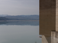 Visible banks, dry soil, and uncultivated vegetation replace the water at Lake Monte Cotugno, a reservoir in Basilicata, which in the summer...