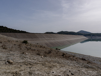 Visible banks, dry soil, and uncultivated vegetation replace the water at Lake Monte Cotugno, a reservoir in Basilicata, which in the summer...