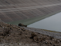 Visible banks, dry soil, and uncultivated vegetation replace the water at Lake Monte Cotugno, a reservoir in Basilicata, which in the summer...