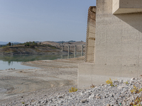 Visible banks, dry soil, and uncultivated vegetation replace the water at Lake Monte Cotugno, a reservoir in Basilicata, which in the summer...