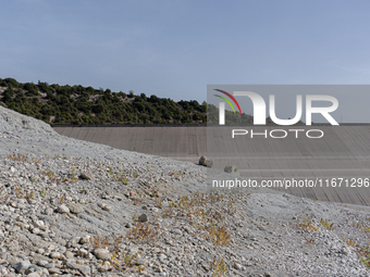 Visible banks, dry soil, and uncultivated vegetation replace the water at Lake Monte Cotugno, a reservoir in Basilicata, which in the summer...