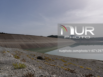 Visible banks, dry soil, and uncultivated vegetation replace the water at Lake Monte Cotugno, a reservoir in Basilicata, which in the summer...