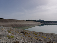 Visible banks, dry soil, and uncultivated vegetation replace the water at Lake Monte Cotugno, a reservoir in Basilicata, which in the summer...